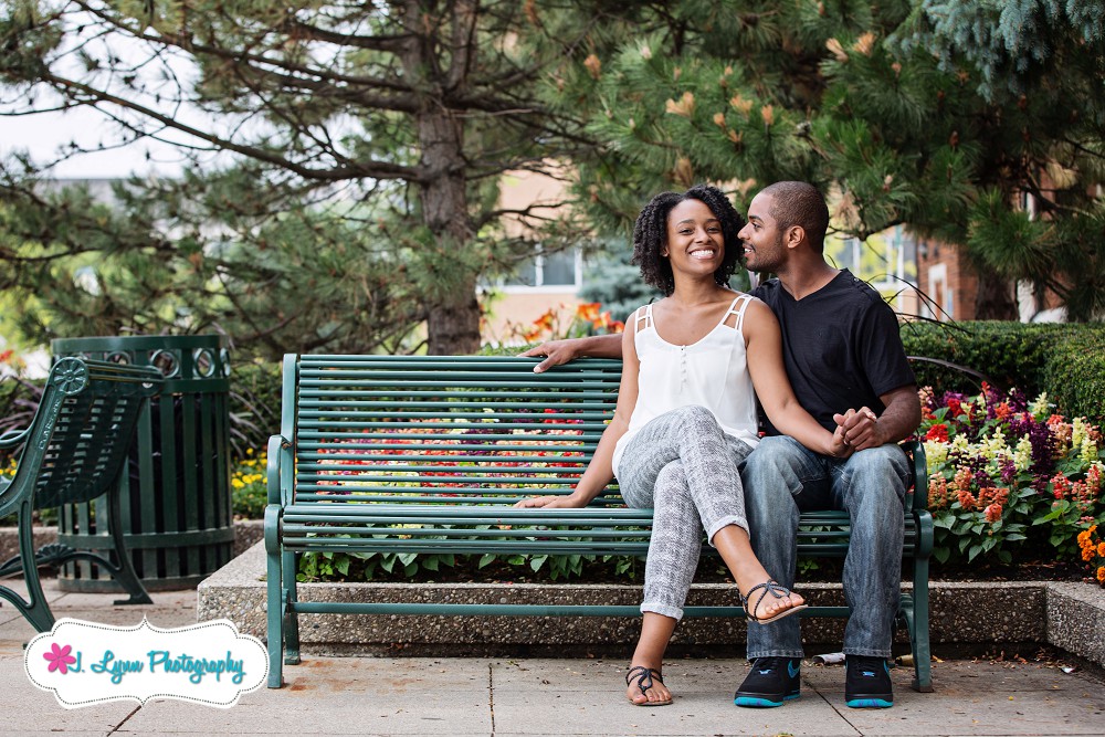 engaged couple sitting on bench in birmingham