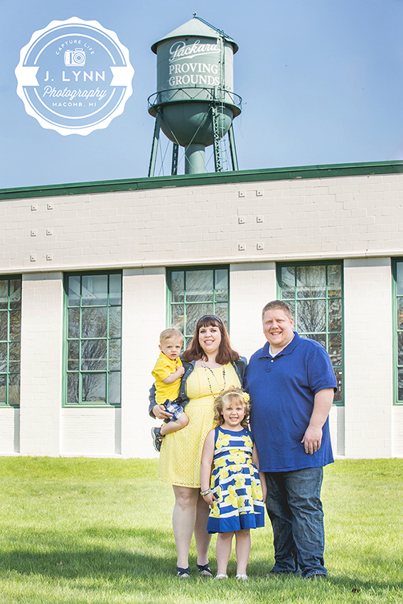 family in front of water tower