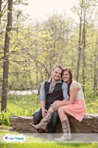 couple sitting on rock in woods