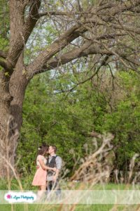 Couple kissing under tree