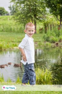 boy near pond at park
