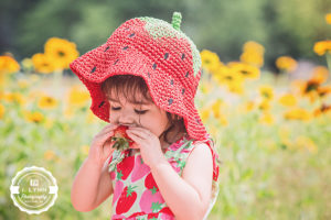 Sunflower girl eating strawberry