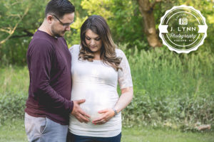 couple touching pregnant belly