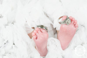 newborn with wedding rings