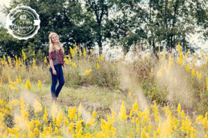 senior picture in wildflower field