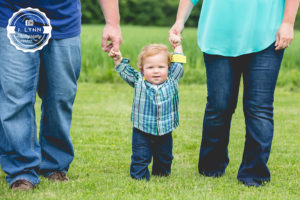 boy holding hands with parents